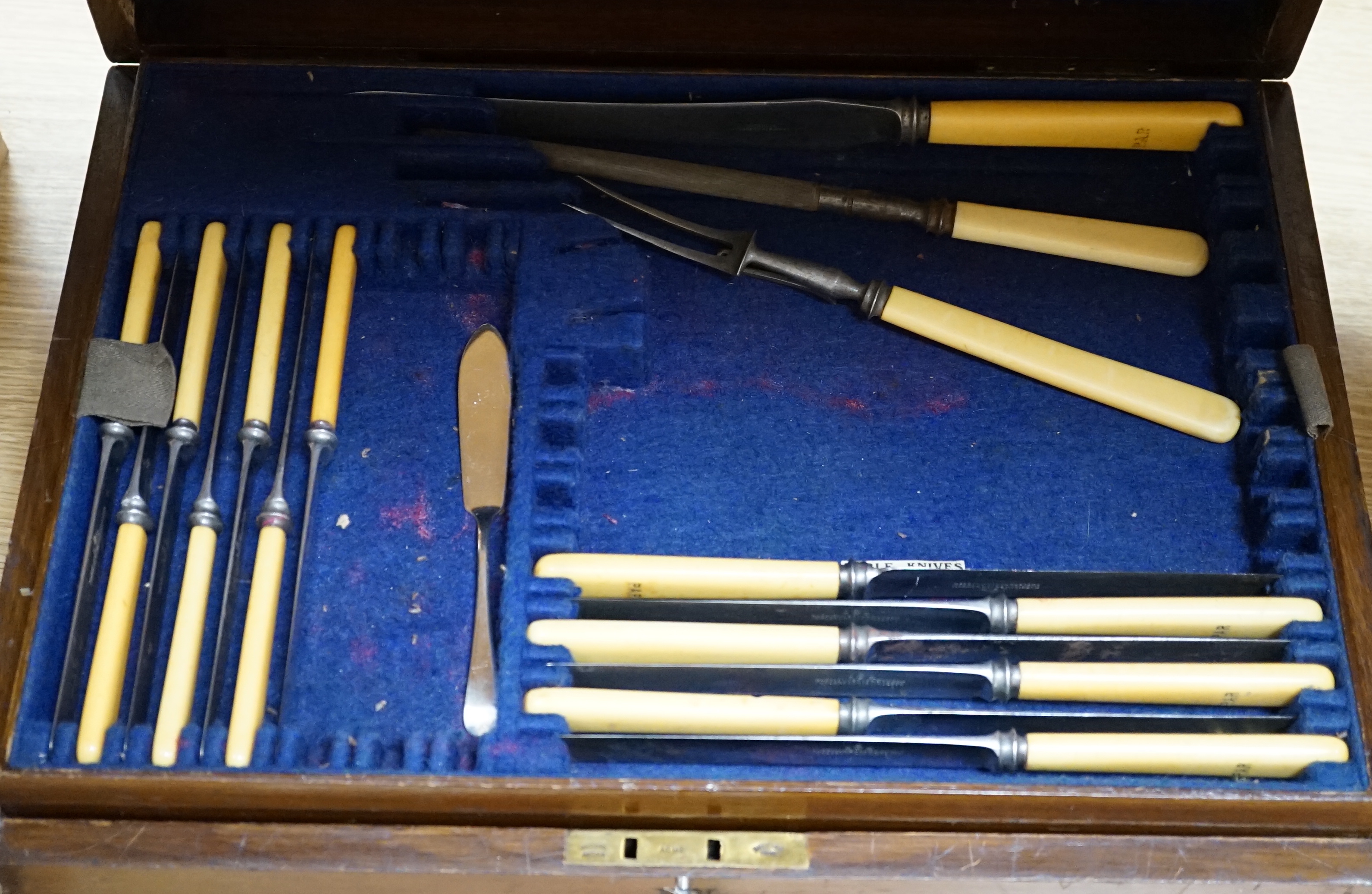 A 20th century oak cased canteen of cutlery, Harrison Bro’s & Howson, the knives with ivorine handles 47cm wide